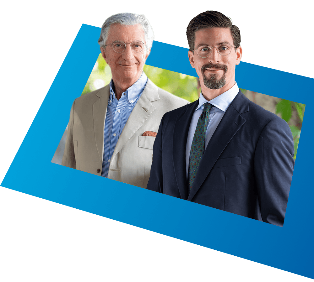 Prof. Edwin Kohl und Philipp Kohl Edwin Kohl und Philipp Kohl in formeller Kleidung vor einem blauen Hintergrund stehend.